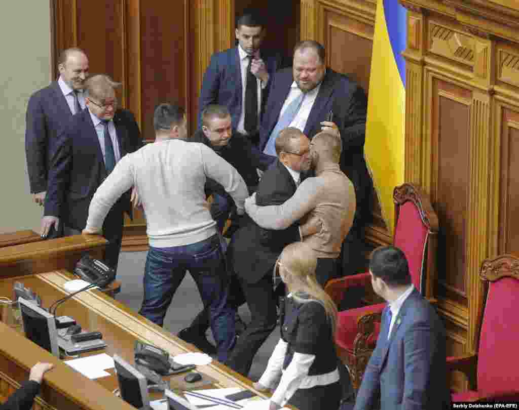 Ukrainian lawmakers clash in Kyiv as they try to block the podium during a hearing to change the laws on the sale of farmland. A moratorium on the sale of farmland has been in place in Ukraine, considered to possess one of Europe&#39;s richest soils, for some 20 years, and liberating the land market has triggered fears that fertile Ukrainian soil could be bought up by foreign investors. (epa-EFE/Sergei Dolzhenko)