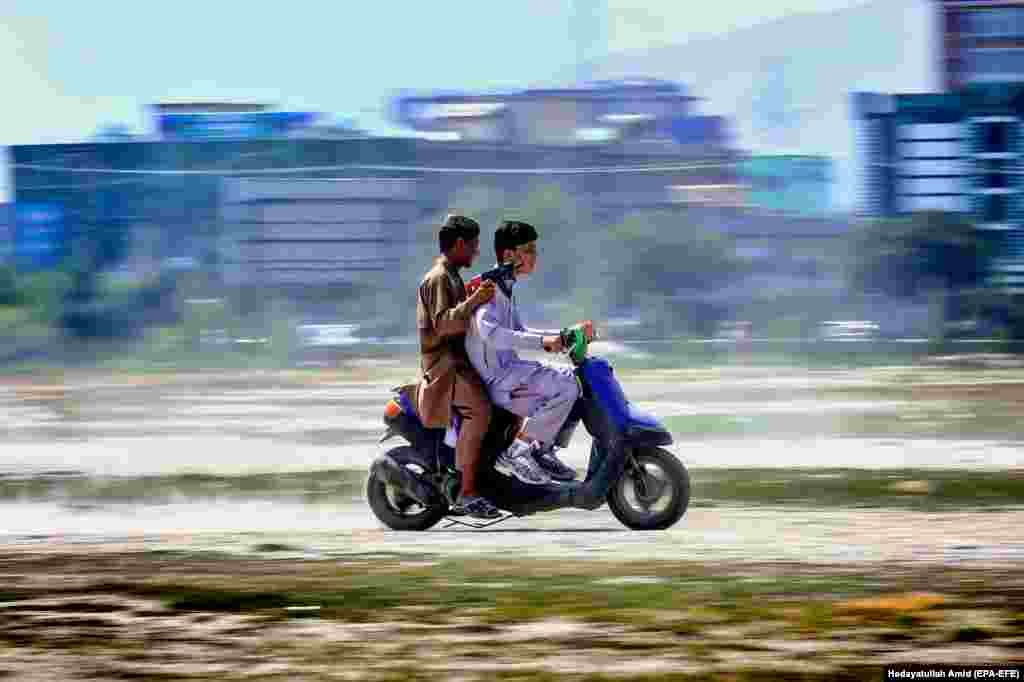 Afghan youths ride a motorcycle in Kabul during celebrations marking Eid al-Adha, the holiest of the two Muslims holidays celebrated each year. It marks the yearly Muslim pilgrimage to visit Mecca, the holiest place in Islam. Muslims slaughter a sacrificial animal and split the meat into three parts: one for the family, one for friends and relatives, and one for the poor and needy. (epa-EFE/Hedayatullah Amid)