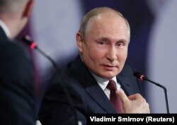 Russian President Vladimir Putin attends a session of the St. Petersburg International Economic Forum in St. Petersburg on June 4.