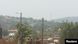 Malian soldiers stand outside the country's main military base near Bamako.