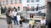 Belarus — Observers who were not allowed to enter the polling station in Minsk are watching from under the school fence, 8aug2020