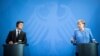 Ukrainian President Volodymyr Zelenskiy (left) and German Chancellor Angela Merkel give statements ahead of talks at the Chancellery in Berlin on July 12.