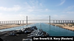 The Nimitz-class aircraft carrier USS Abraham Lincoln approaches the Mubarak Peace Bridge as it transits the Suez Canal in Egypt, May 9, 2019.