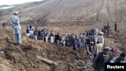 Afghan villagers gather at the site of a landslide in the Argo district in Badakhshan Province on May 2.