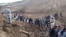 Afghan villagers gather at the site of a landslide in the Argo district in Badakhshan Province on May 2.