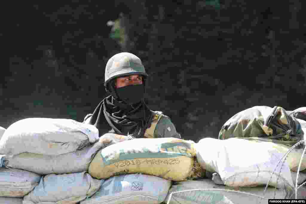 An Indian paramilitary soldier stands guard at check post along a highway leading to Ladakh, at Gagangeer some 81 kilometers from Srinagar, the summer capital of Indian Kashmir, 17 June 2020.&nbsp;India and China fought a brief war in Ladakh and in northeastern India in 1962. Mutual distrust has occasionally led to flare-ups since. Infrastructure work near or within disputed territories is frequently followed by increased tension. The Line of Actual Control (LAC) largely follows a ceasefire line after the 1962 war, but the two sides disagree on where it lies.