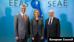 Kosovar Prime Minister Isa Mustafa (right), Kosovar President Hashim Thaci (l) and European Union foreign policy chief Federica Mogherini attend talks on establishing normal relations between Serbia and Kosovo in Brussels on January 24. 