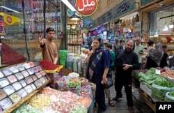 People shop for produce at the Tajrish bazaar in northern Tehran on August 25.