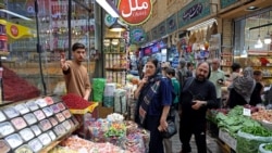 People shop for groceries at the historic Tajrish bazaar in northern Tehran on August 25.
