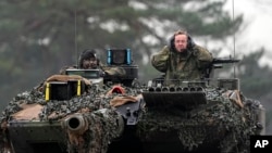 German Defense Minister Boris Pistorius (right) sits in a Leopard 2 tank in Augustdorf, Germany, on February 1.