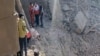 A video grab taken from UGC images posted on social media on February 28 and verified by AFP shows people inspecting the damage at an impact site following US and Israeli strikes on Tehran.