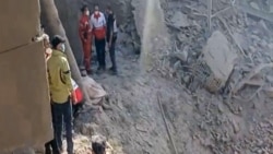 A video grab taken from UGC images posted on social media on February 28 and verified by AFP shows people inspecting the damage at an impact site following US and Israeli strikes on Tehran.