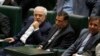 Iran's Foreign Minister Javad Zarif (L), attends a parliament session to discuss the president's proposed cabinet in Tehran, August 15, 2017