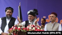 Ashraf Ghani (C), Afghan incumbent president and presidential candidate, stands with Amrullah Saleh (R), his vice presidential candidate, during his election campaign in Jalalabad on September 20.