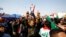 Iraqi demonstrators chant slogans during ongoing anti-government protests in Najaf, February 6, 2020