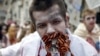 A demonstrator dressed as a zombie protests in Ukraine against Russian propaganda by stuffing his mouth with newsprint and St. George's ribbons, a symbol used by pro-Russia rebels in the east. 