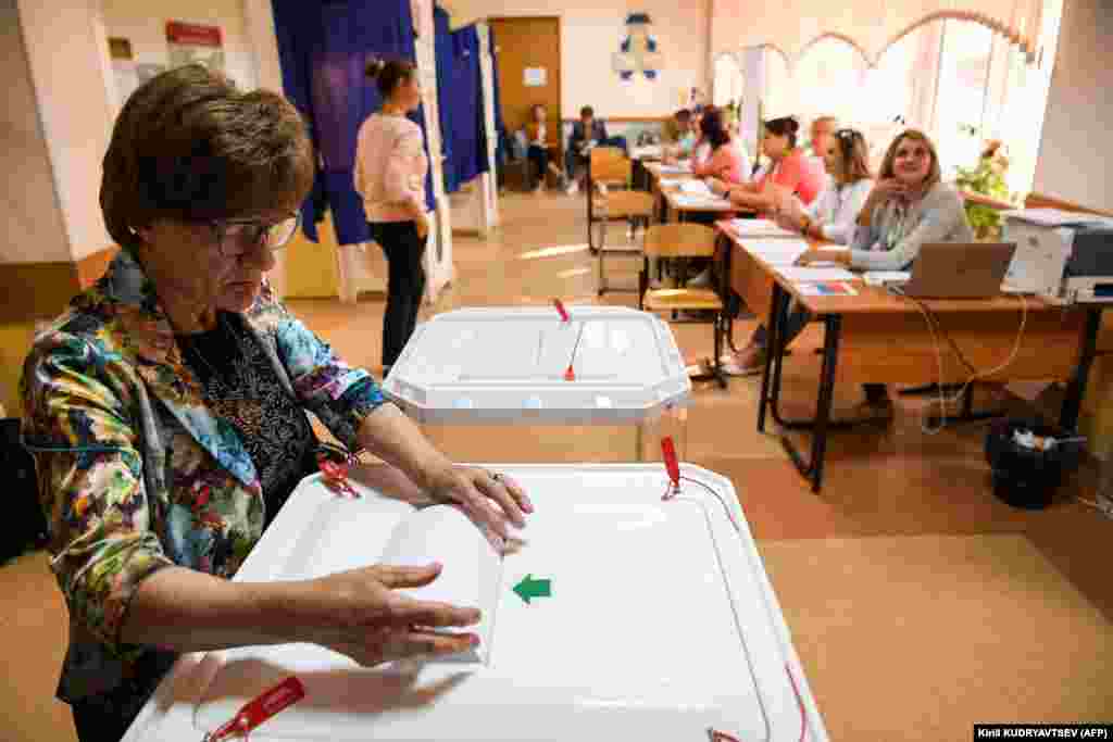 A woman casts her vote at a polling station in Moscow.