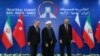 Iran's President Hassan Rouhani (C), flanked by Russia's President Vladimir Putin (L), and Turkey's President Recep Tayyip Erdogan, after posing for photographs in Tehran, Iran, ahead of their summit to discuss Syria, Friday, Sept. 7, 2018.