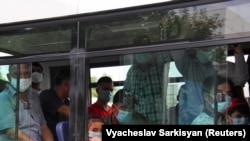 People wearing protective face masks inside a bus in Ashgabat, Turkmenistan's capital