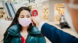 A woman has her temperature checked as a preventive measure against the coronavirus at a shopping mall in Nur-Sultan on May 4.