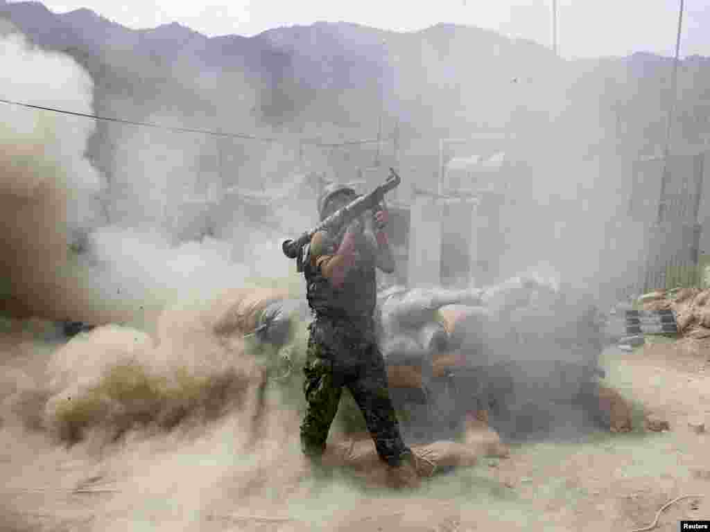 An Afghan national army soldier fires a rocket propelled grenade during a fire fight between Taliban militants and Afghan and U.S. soldiers in Kunar Province, Afghanistan on July 18.Photo by Baz Ratner for Reuters