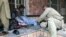 People attend to a man injured in a blast in the Afghan city of Mazar-e Sharif on March 11. 