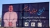 Afghan people walk past an electoral billboard of Abdul Jabar Qahraman, a prominent Afghan politician and candidate of upcoming Parliamentary elections, after he was killed in a suicide bomb attack, in Helmand on October 17.