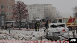 Police officers inspect a damaged apartment building following a Russian attack on Kyiv on January 9.