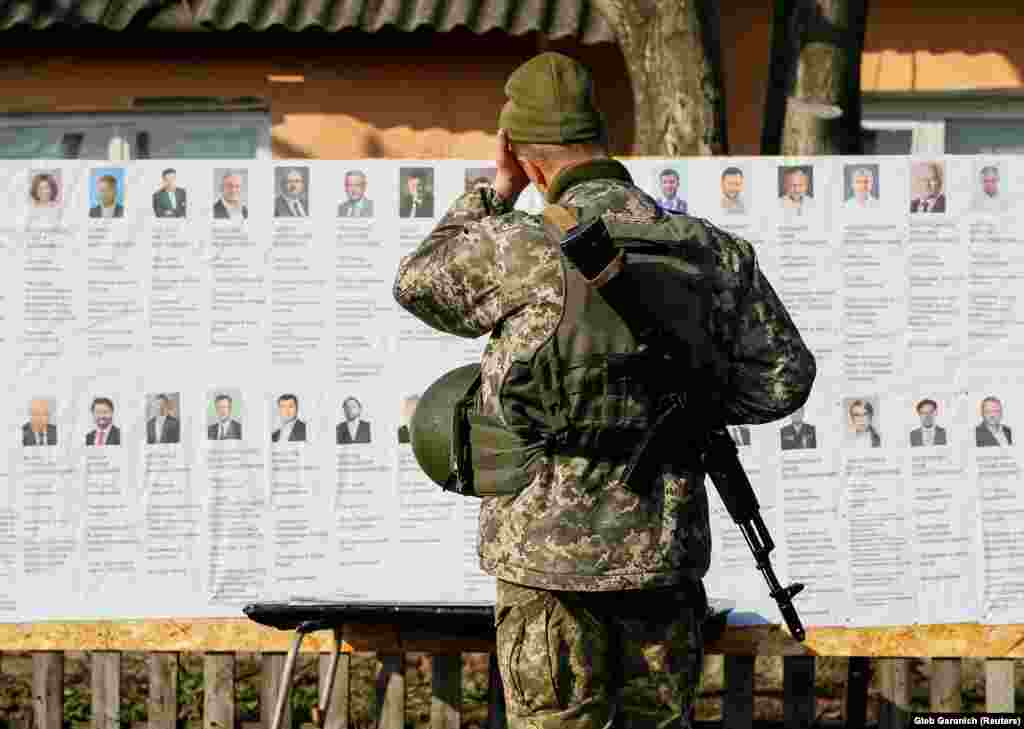 A Ukrainian serviceman studies presidential candidates at a polling station near the front line against Russia-backed separatists, in the village of Zaitseve, eastern Ukraine. (Reuters/Gleb Garanich)