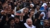 Afghan Shi'a hold posters and chant slogans during a demonstration in Herat on January 3.