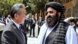 Taliban Foreign Minister Amir Khan Muttaqi welcomes Chinese Foreign Minister Wang Yi to Kabul ahead of a August 20 trilateral meeting with Pakistan. 