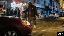Taliban security personnel stand guard at the blast site following a January 19 explosion on a Chinese hotel restaurant in Kabul that was claimed by Islamic State-Khorasan Province (IS-K). 