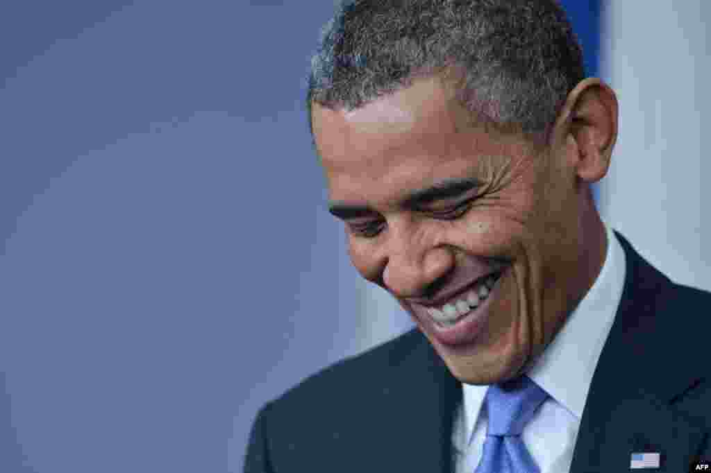 U.S. President Barack Obama enjoys a moment of levity during his end-of-year press conference at the White House in Washington on December 20. (AFP/Nicholas Kamm)