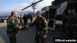 The breakaway Nagorno-Karabakh region’s leader Bako Sahakyan (left) greets Armenian President Serzh Sarkisian at Stepanakert airport on November 13.