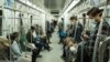 Commuters wearing masks against coronavirus on Tehran underground (Metro) on April 7, 2020. 