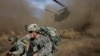 FILE U.S. and Afghan soldiers race to get out of the way of a CH-47 Chinook helicopter landing.