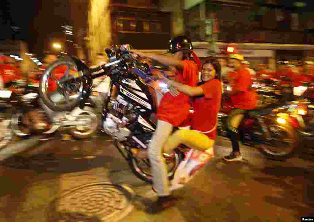 Supporters of Venezuelan presidential candidate Nicolas Maduro celebrate in Caracas after official results gave him a victory in the April 14 vote to replace the late Hugo Chavez. (Reuters/Edwin Montilva)