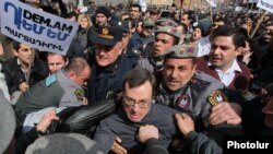Armenian riot police clash with activists protesting against pension reform in Yerevan last month.
