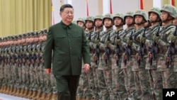 Chinese leader Xi Jinping reviews troops during his inspection of the Chinese People's Liberation Army (PLA) garrison stationed in the Macao Special Administrative Region on December 20.