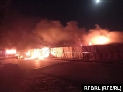 Shops on fire in the Andkhoi district of Faryab Province during fighting between Afghan forces and Taliban insurgents in June 2021.