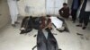 The bodies of some of the 60 Afghans killed in the blasts lie on the ground at a hospital in Kabul on August 26.