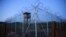 Chain link fence and concertina wire surrounds a guard tower within Joint Task Force Guantanamo's Camp Delta at the U.S. naval base in Guantanamo Bay, Cuba.