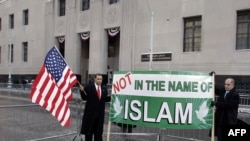 Demonstrators outside the court in Detroit hold a sign reading "Not in the name of Islam."