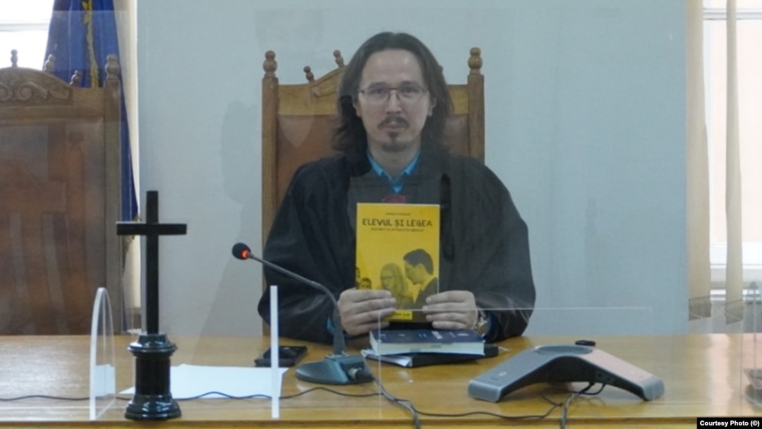 Romania Judge Cristi Danilet poses with his book The Student And The Law. (file photo)