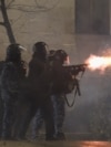 Police in riot gear fire tear gas during a fourth day of nationwide protests against a government decision to shelve EU membership talks in Tbilisi early on December 2, 2024.