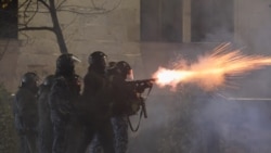 Police in riot gear fire tear gas during a fourth day of nationwide protests against a government decision to shelve EU membership talks in Tbilisi early on December 2, 2024.