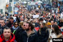 Участники демонстрации протеста против ограничений, связанных с пандемией, в немецком городе Кассель, 20 марта 2021 года