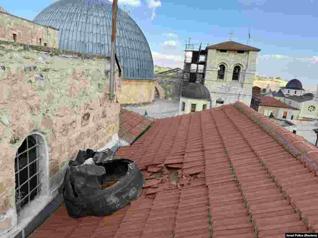 Part of a missile seen on a rooftop alongside the Church of the Holy Sepulchre in Jerusalem (metal dome in background) on March 16. The church is widely believed to stand at the site where Jesus was crucified.