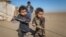 Internally displaced Syrian children who fled Raqqa stand near their tent in Ras al-Ain Province in January 2017.