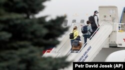 Diplomatët rusë dhe familjet e tyre duke u larguar nga Praga, 19 prill, 2021.